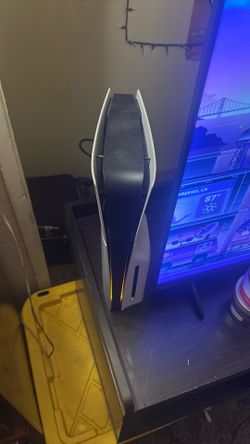 PlayStation 5 with two controllers and the cords