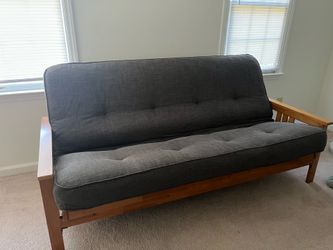 Large grey futon with sturdy wooden frame