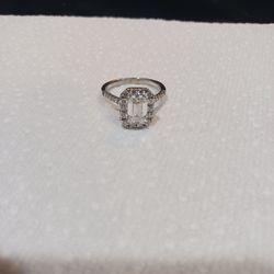 White gold ring with an emerald cut center stone surrounded by a halo of round accent stones it's real 14kt absolutely beautiful asking $4000 cash no 