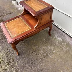 vintage, two-tier French Provincial style step end Side table featuring a wood frame 