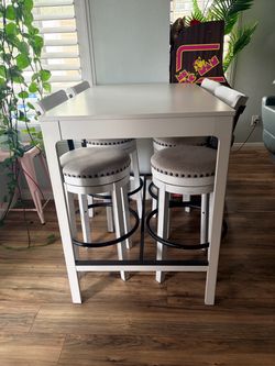 White pub height table with 4 sturdy heavy chairs