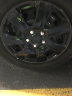 Black 7-spoke car wheel and tire