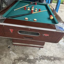 Fischer bumper pool table. Approx. 3X5 ft. Balls and 4 cues and chalk holder. In excellent brand new shape. Slate top.