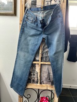 7 for All Mankind brand blue denim jeans.
