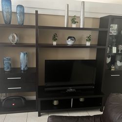 Modern dark wood entertainment center with matching dark wood and marble coffee table, side tables and console