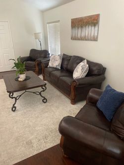 Brown leather couch and two chairs set