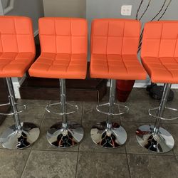 New Set Of 4 Orange Bar Stools / Adjustable Height And Swivel / Price Is Firm / Pick Up Only / Orange Pub Stools  new in  box
