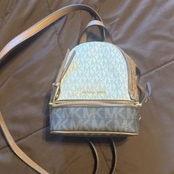 Michael Kors Rhea mini color-block logo backpack in vanilla and brown signature-print canvas.