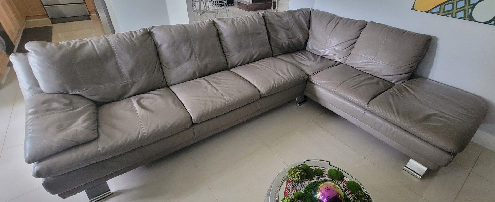 Gray Leather sectional and Black leatherette chair (If you see it here, is available)