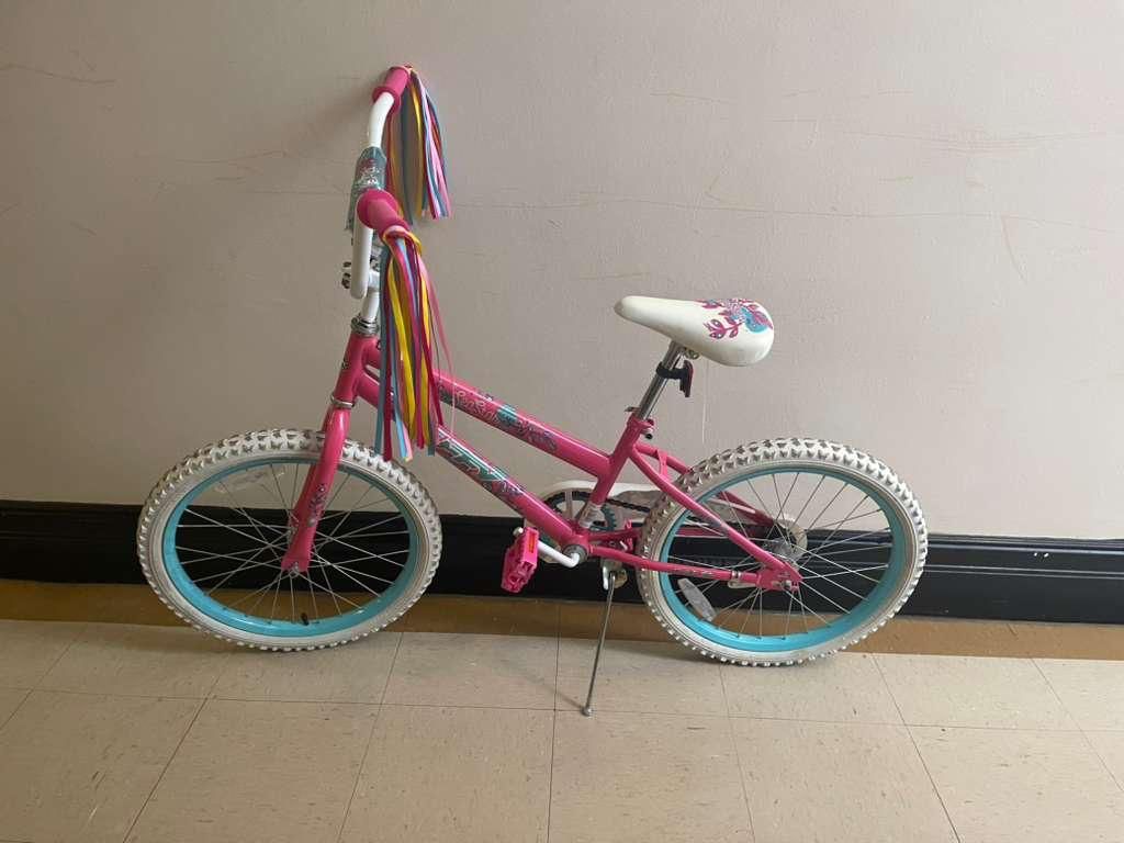The Huffy Illuminate Bike for Girls is a children's bike available in 12, 16, and 20-inch sizes, featuring a sky blue frame with pink accents, white t