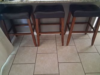 3 Faux tufted leather barstools with tapered legs