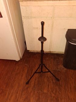 Foldable metal trombone stand.