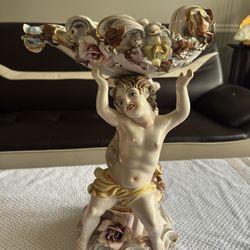 MEISSEN PORCELAIN CENTERPIECE, With one Putti Supporting A Flower Encrusted Basket; Height: 17”1/2