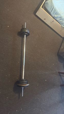 BARELY used weight plates with  bar (72.5 Ibs)