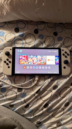 Nintendo Switch OLED + 12 Games + Case - $550