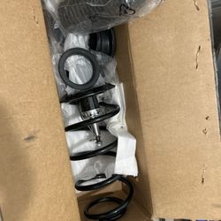 Front strut assembly with coil spring