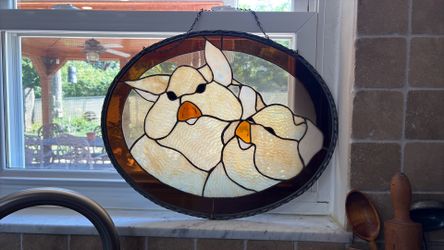 Stained glass artwork of pigs
