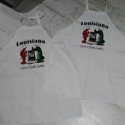 Pair white aprons say Louisiana we're really cookin BRAND NEW crawfish alligator