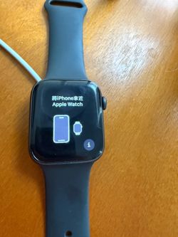 Space Gray Apple Watch SE 44mm with charger