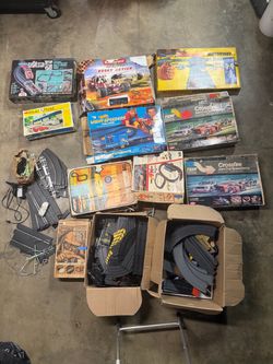 Collection of vintage toy car racing sets untested