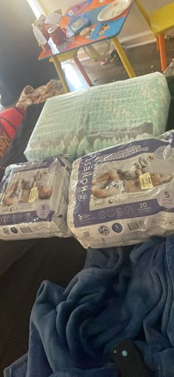 Two brand new packs of diapers in one hat pack has seven the sides just were ripped from being stored away their size 5