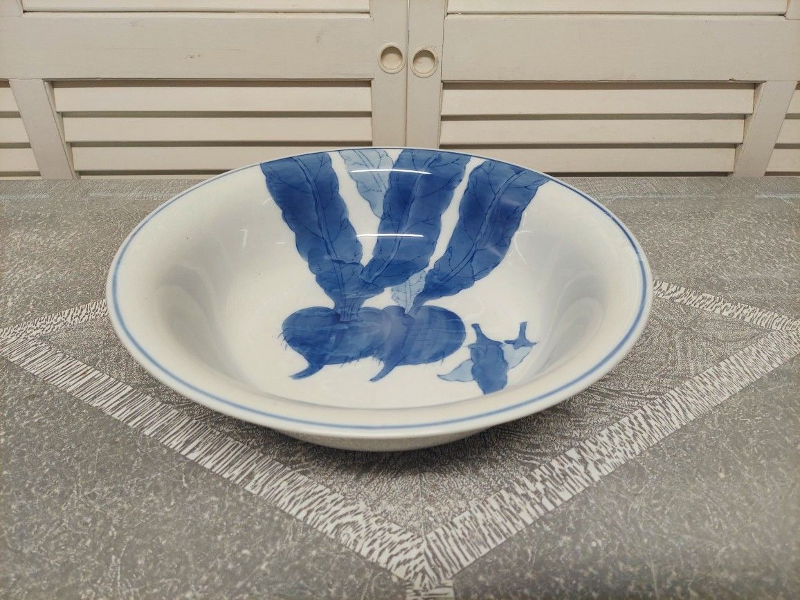Blue and White Porcelain Bowl with Beets and Chile Peppers Inside .
