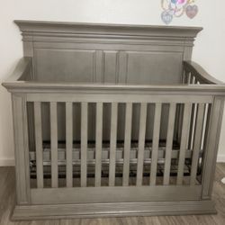 Baby crib that turns into a toddler bed and a full-size bed later on