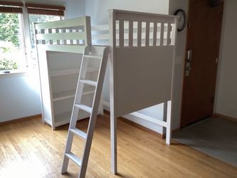 Loft bed with bookshelf and whiteboard.