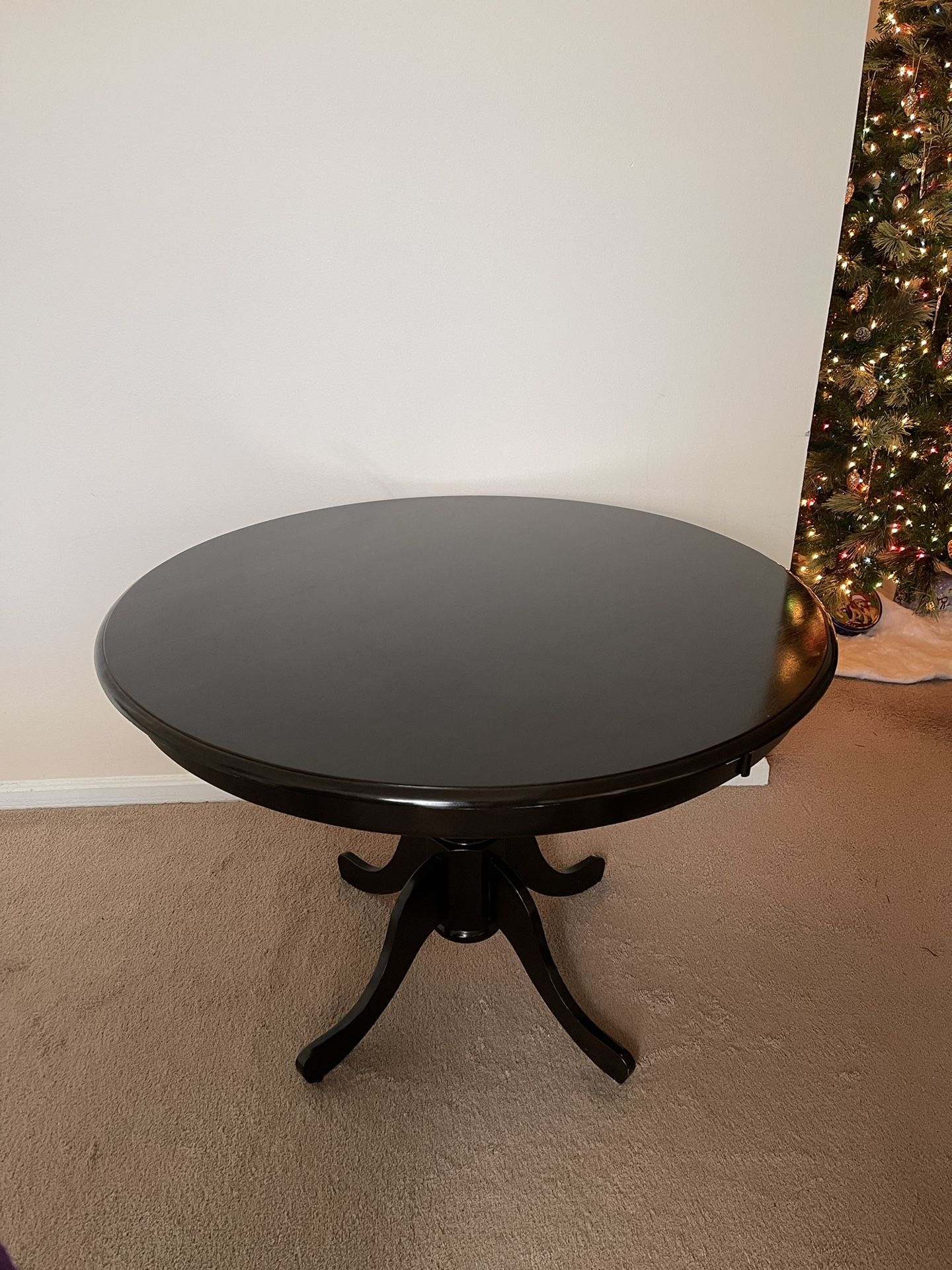 Cappuccino Asian Wood Dining Table. Round Table Top with Pedestal Legs. Wood construction and solid wood tabletop.