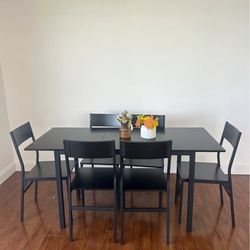 Black wood dining table with chairs