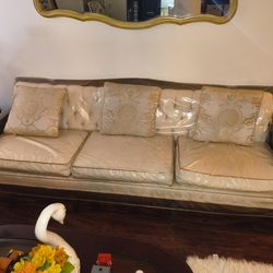 Antique sofa and 2 chairs with plastic covers and pillows