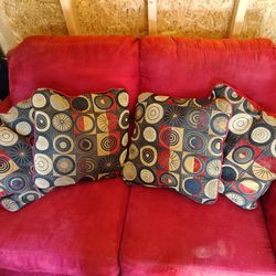 Red sleep sofa and loveseat with 4 matching pillows