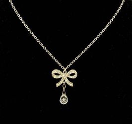 Crystal bow pendant necklace with faceted briolette teardrop charm very feminine