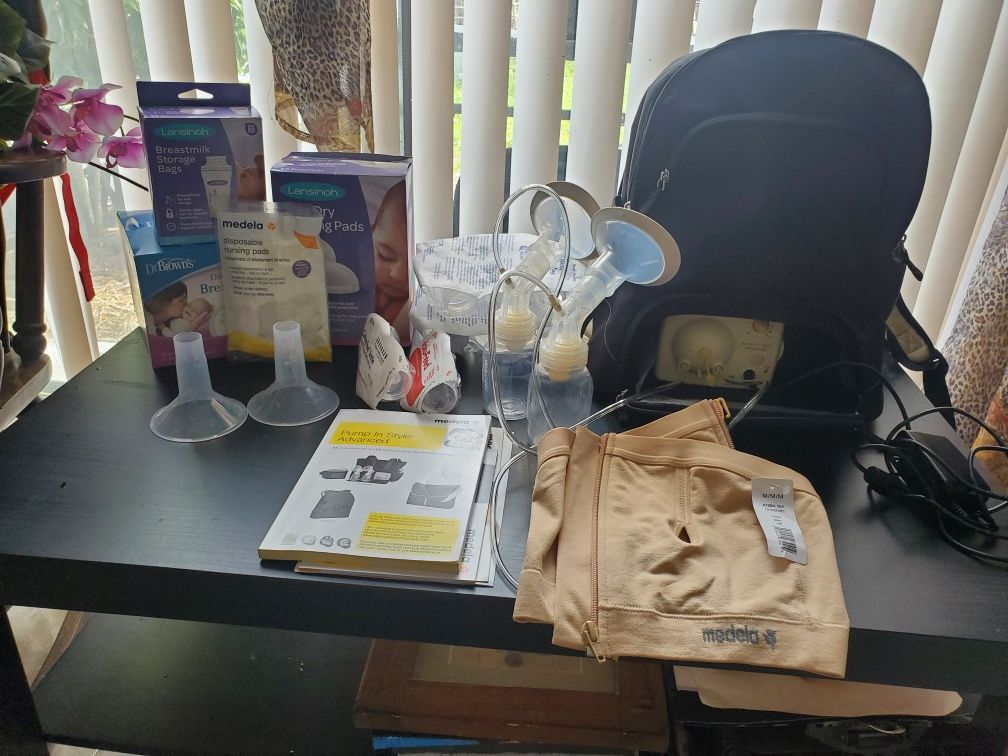 Medela breast pump, diapers, breast pads, storage containers
