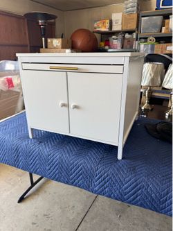 New white cabinet with two doors and slide out board $50