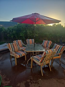 Table. Chairs. Chair cushions. Umbrella. Umbrella stand. Table set.