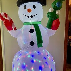 An Inflatable Light-up Snowman Christmas Yard Decoration.