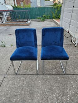 2 blue velvet chairs