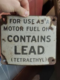 Antique porcelain gas pump sign contains lead