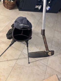 Putter, bag and golf hat