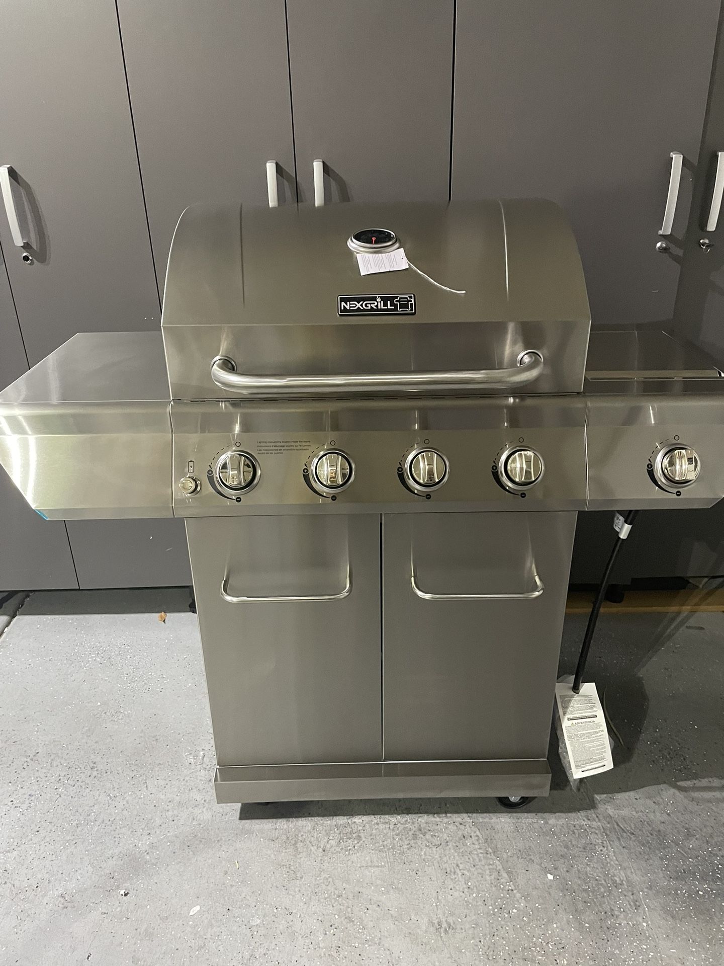 Nexgrill 4-Burner Propane Gas Grill in Stainless Steel with Side Burner and Stainless Steel Doors