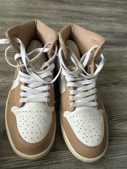 Tan/White High Tops - Air Jordan 1 Mid "Hemp/White" (also called a linen/sand colorway). The cream midsole and gum outsole match this style.