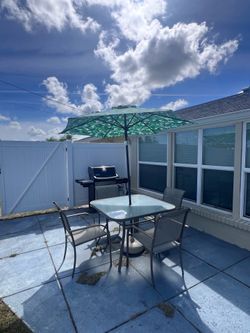 Table and four chairs with umbrella