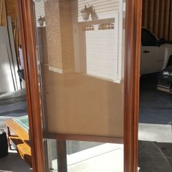 Lighted curio cabinet with glass shelves, back mirror missing