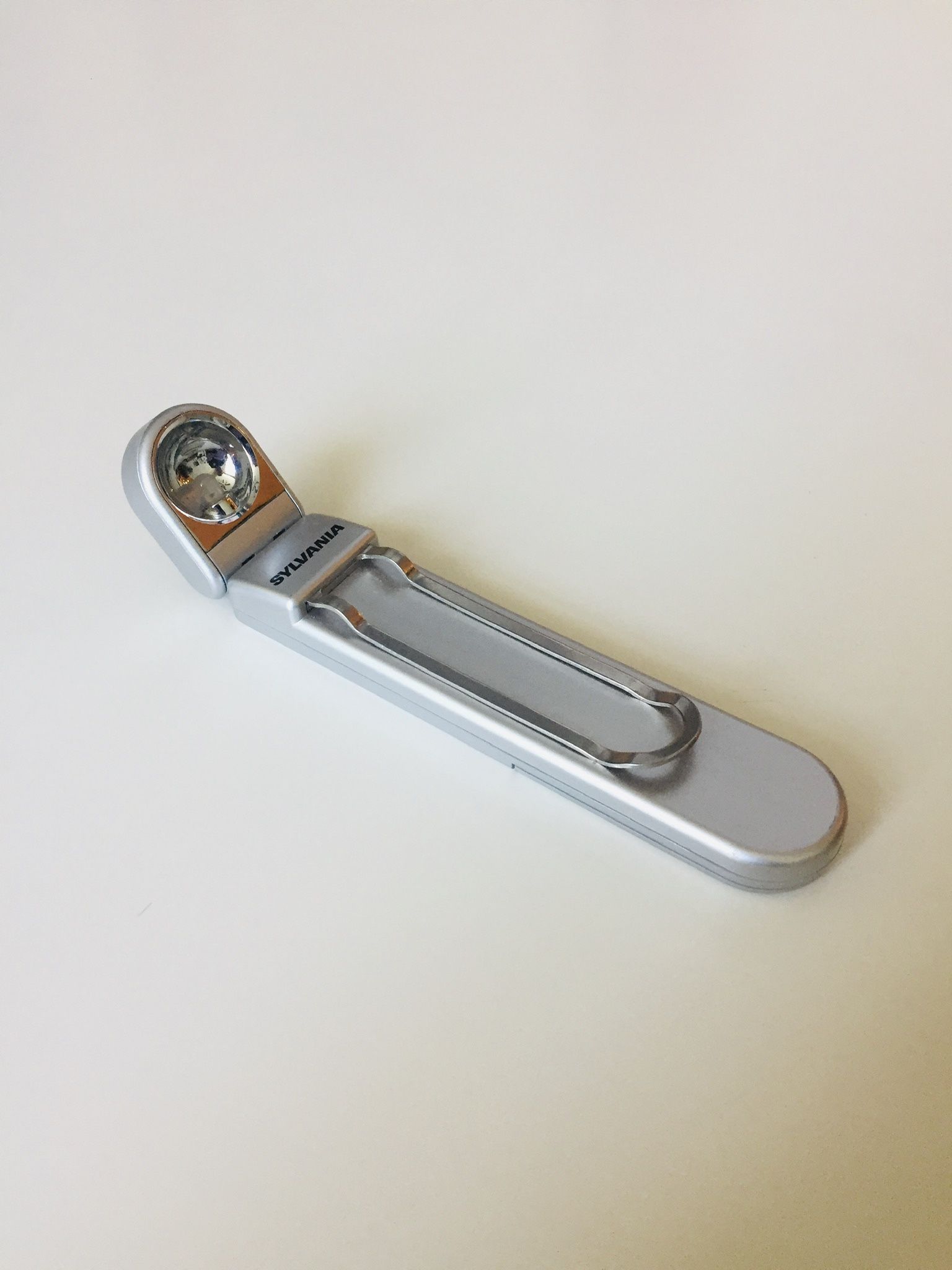 Elegant Small Folding Flash Light with clip. Very convenient. Allows you to reach unreachable areas with light. Like new.