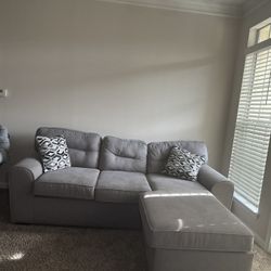 Grey Couch With Two Pillows