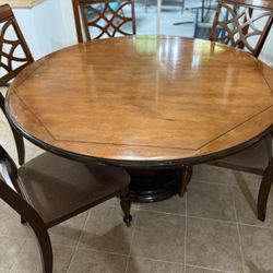 ATELIERS de la MADELEINE, solid wood pedestal dining table measuring L: 58" x W: 58" X H: 29". 