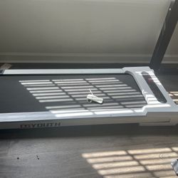  electric standing desk with a dual-tone desktop and an under-desk treadmill 