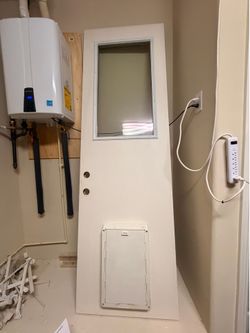 Side  Door with large doggy door and glass , size 30 x 95 white in good condition , one side is white, another -brick color-pick up 89131 zipcode by F