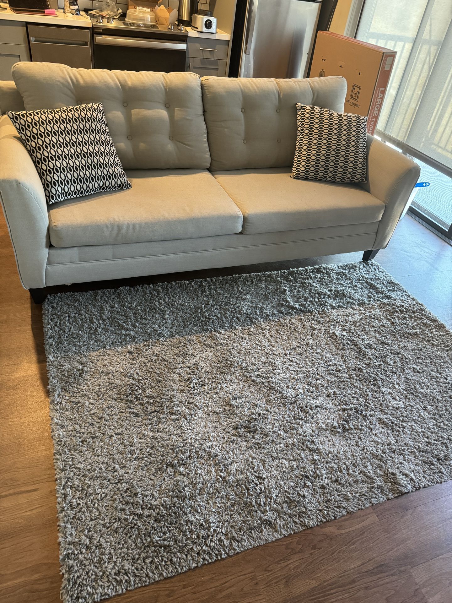 Super light weight Nautical super comfortable 3 seater couch paired with a 5by 7ft gray rug.